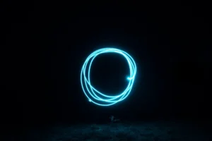A glowing blue circle represents Australian Investment Education’s Trader Circle, symbolizing trading success, coaching, and real-world strategies.