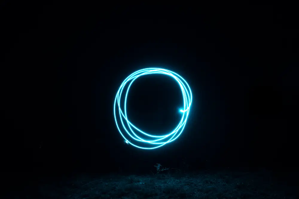 A glowing blue circle represents Australian Investment Education’s Trader Circle, symbolizing trading success, coaching, and real-world strategies.