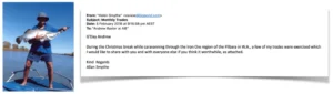 This image is a testimonial post featuring a photo and an email. On the left, there is a photo of Allan Smythe standing on a boat, wearing a hat, shorts, and a blue shirt, holding up a large fish (likely a Barramundi) over the water. On the right is an email sent on 5 February 2018 from "Helen Smythe" (but signed "Allan Smythe") to "Andrew Baxter at AIE" with the subject "Monthly Trades." The email explains that he is sharing an update on trades that were exercised while he was caravanning through the Iron Ore region of the Pilbara in W.A. during the Christmas break. (Note: The actual trade results appear to be in an attachment not visible in the image.)